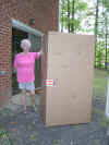Mom standing beside cycle in box